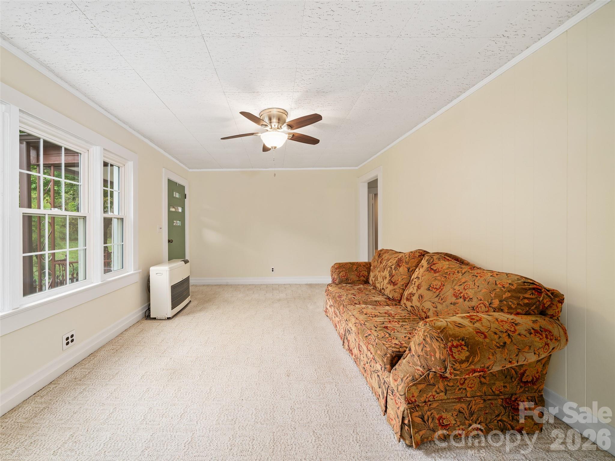 338 Sweet Creek Road Bakersville, NC 28705 - Photo 4 of 21 a living room with a couch and a chandelier