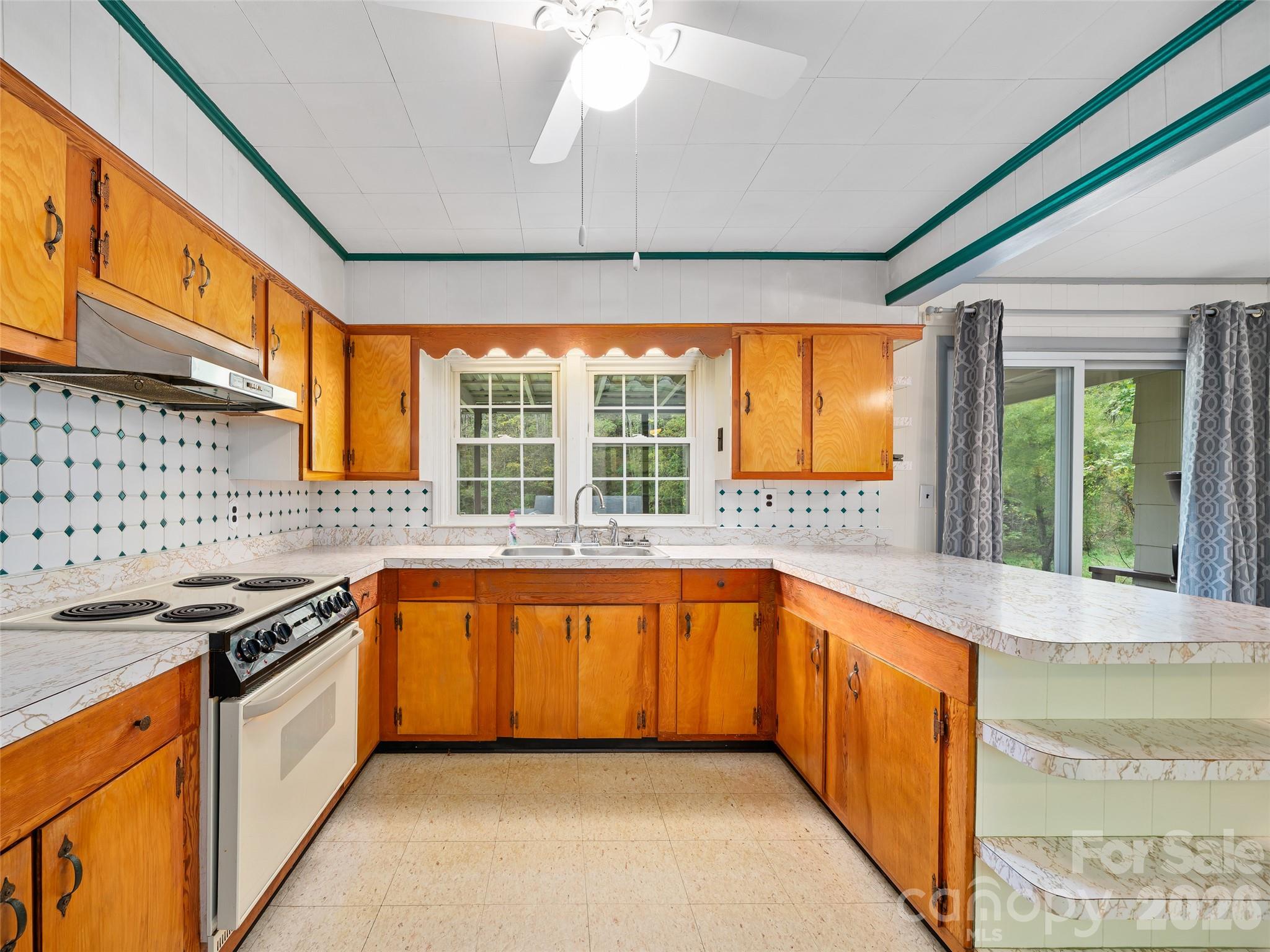 338 Sweet Creek Road Bakersville, NC 28705 - Photo 10 of 21 a kitchen with stainless steel appliances granite countertop a sink and a stove