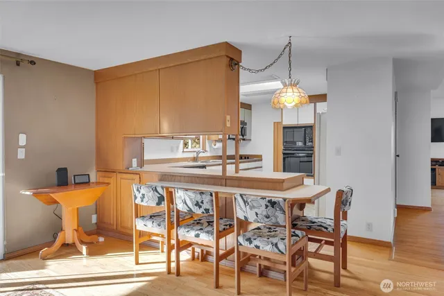 a view of a dining room with furniture and wooden floor