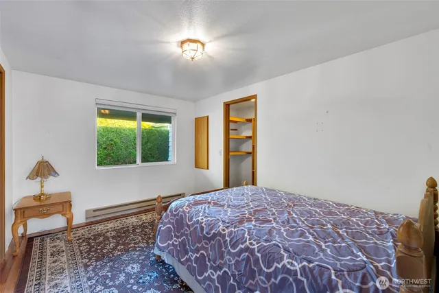 a bedroom with a bed and a window