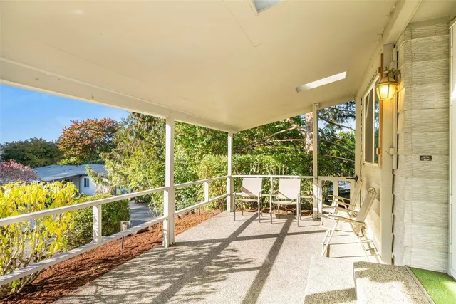 a view of a balcony with floor to ceiling windows and wooden floor
