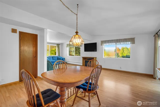 a view of a dining room with furniture window and wooden floor