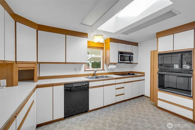 a kitchen with stainless steel appliances granite countertop a stove and a sink