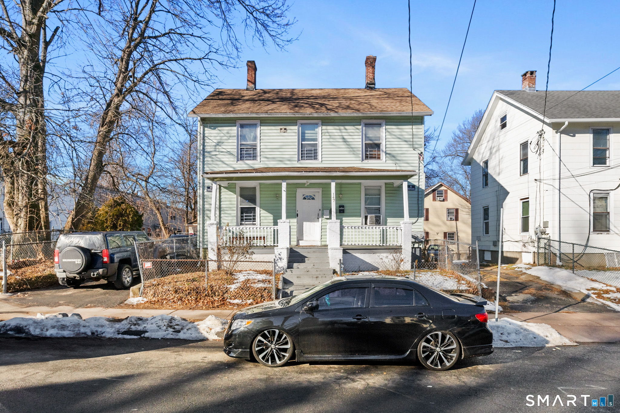 a car parked in front of a brick house