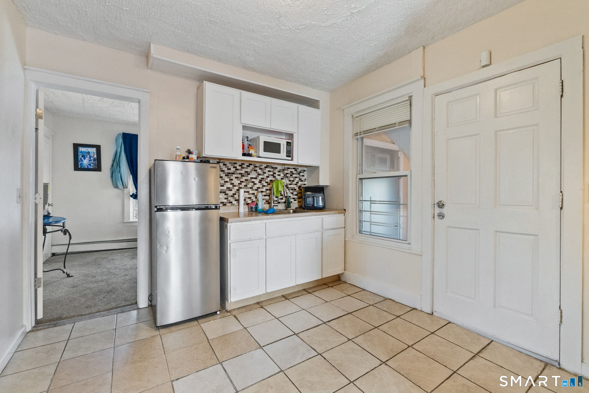 147 Martin Street Hartford, CT 06120 - Photo 19 of 34 a kitchen with white cabinets and refrigerator
