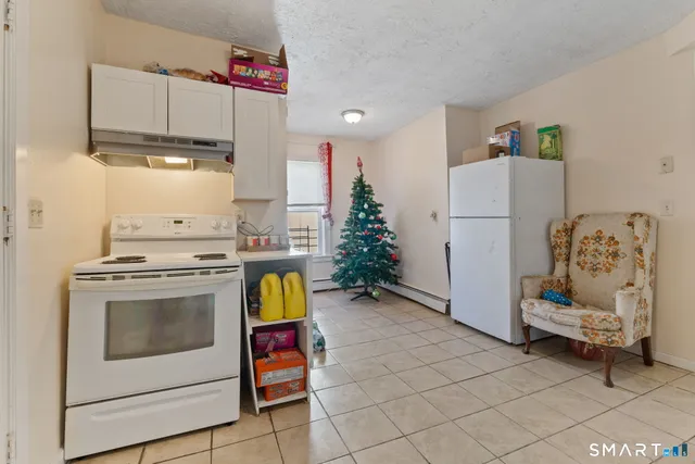 a kitchen with a stove a refrigerator and a stove top oven