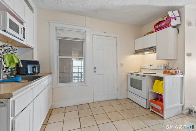 a kitchen with a sink a stove and cabinets