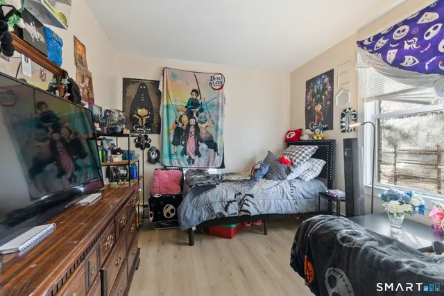 a bedroom with two beds and a window