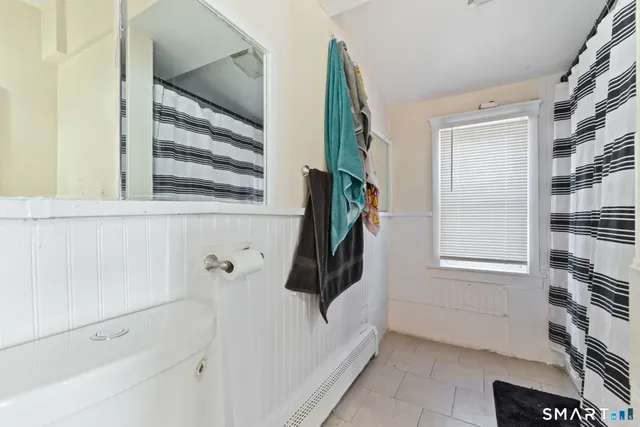 a bathroom with a bathtub and a window