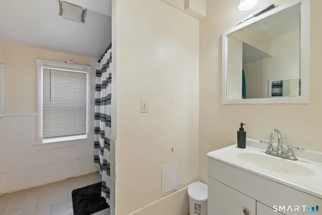 a bathroom with a sink toilet and vanity