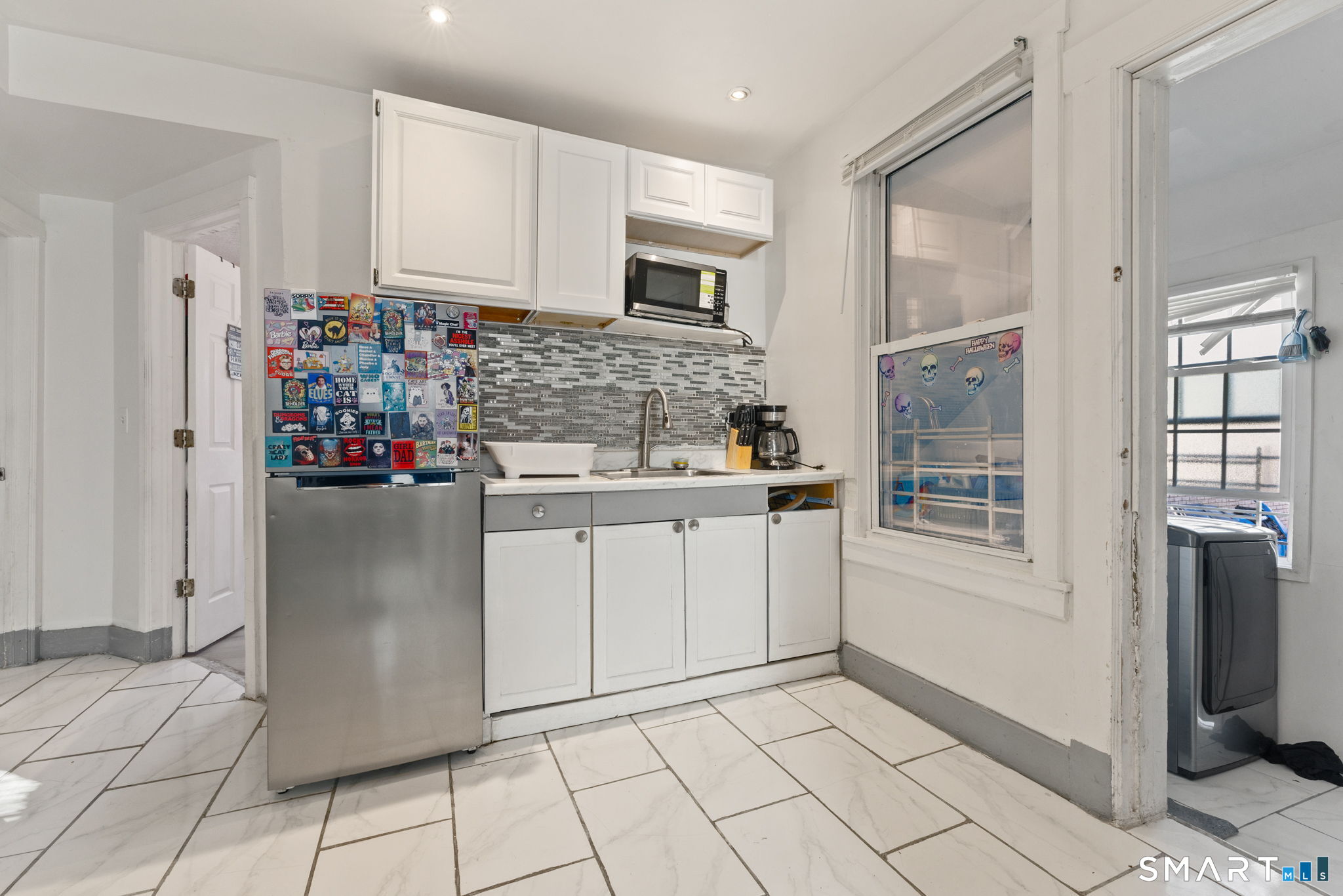 147 Martin Street Hartford, CT 06120 - Photo 9 of 34 a kitchen with stainless steel appliances granite countertop a refrigerator and a stove top oven