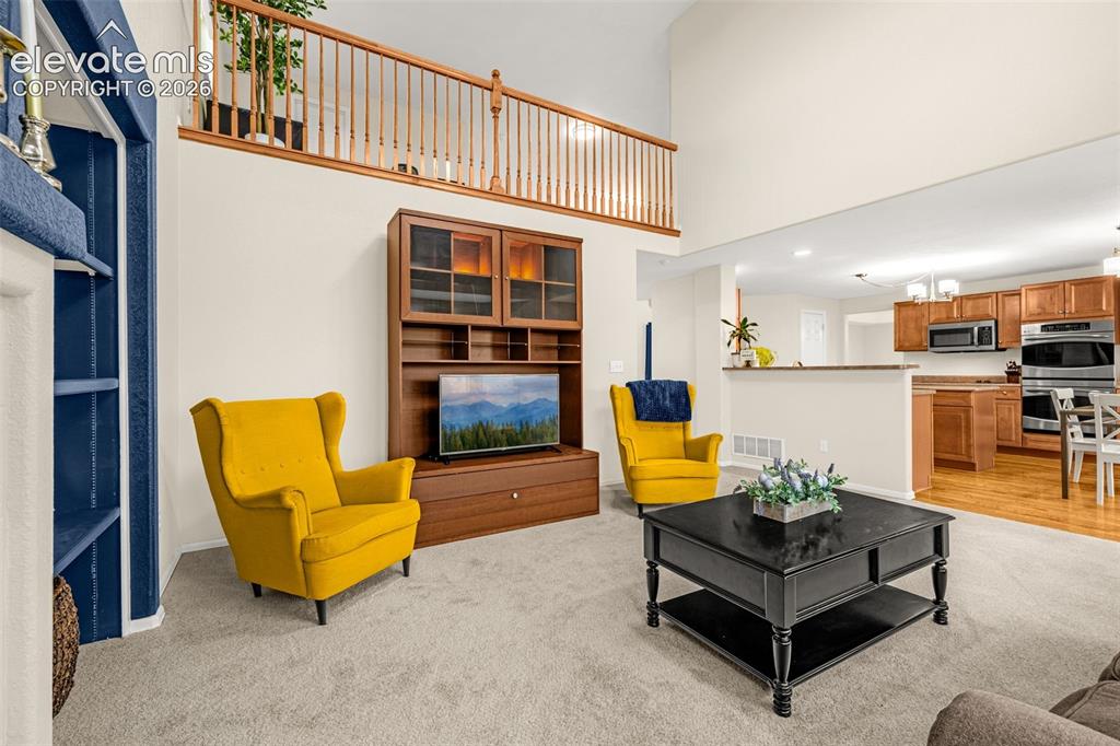9127 Oakmont Road Peyton, CO 80831 - Photo 13 of 49 a living room with furniture pool table and kitchen view