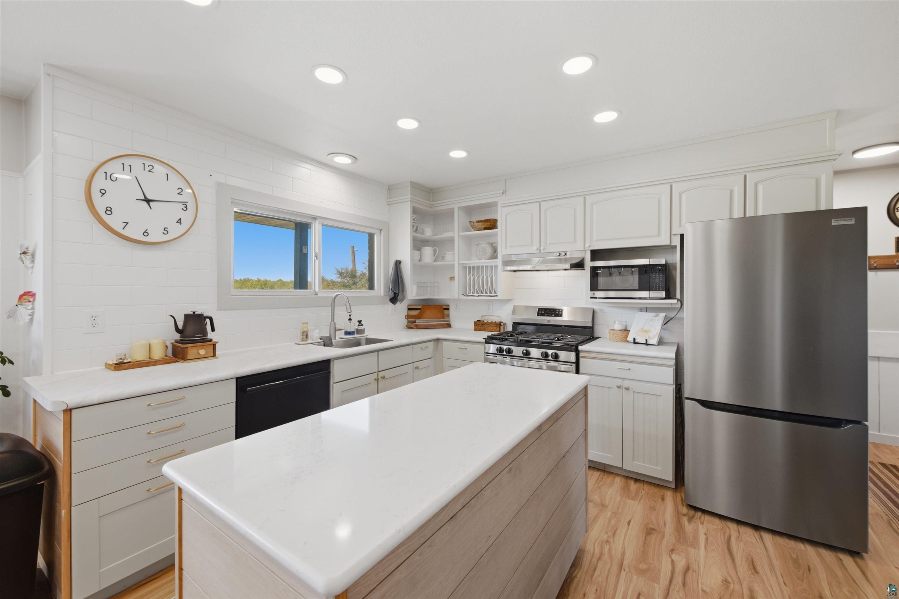 64260 Jolma Road Ashland, WI 54806 - Photo 6 of 35 Kitchen featuring a center island, recessed lighting, wood-finish flooring, and stainless steel appliances