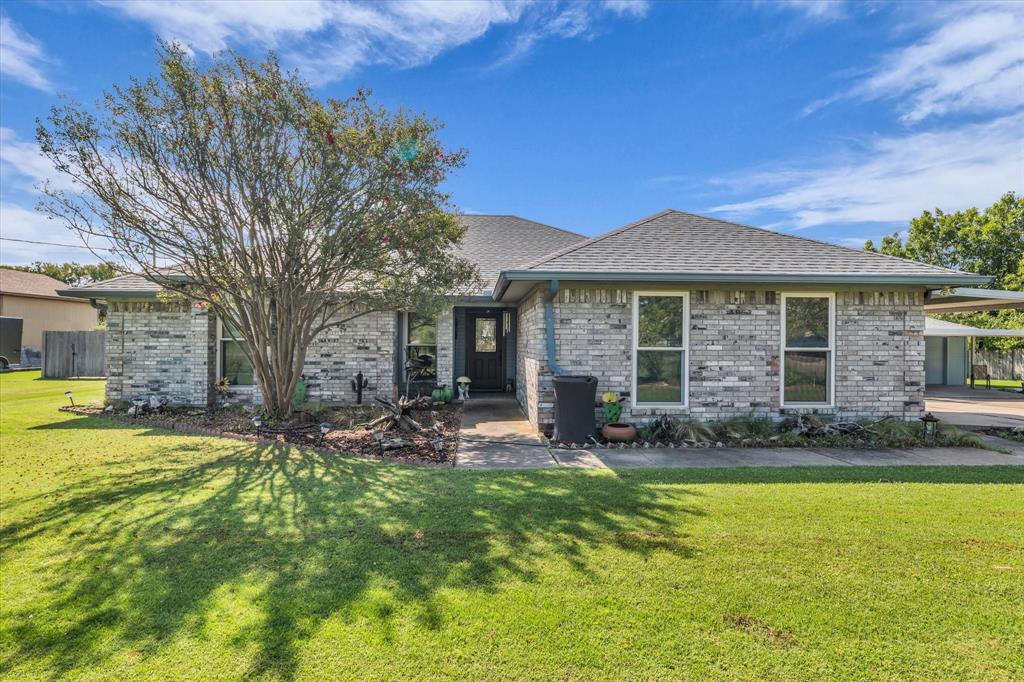 107 Fort Graham Circle Waco, TX 76705 - Photo 1 of 39 View of front facade featuring a front yard, brick siding, and roof with shingles