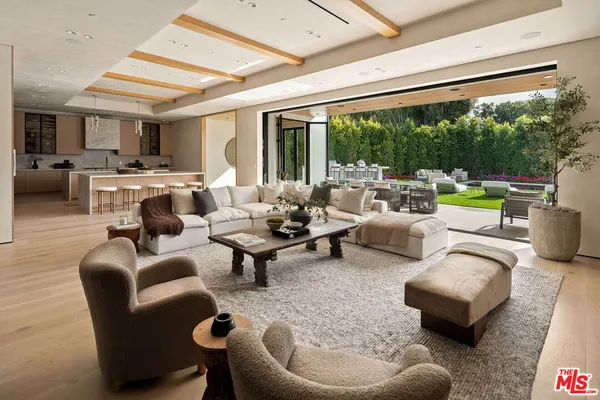 a dining hall with stainless steel appliances granite countertop a sink and a refrigerator