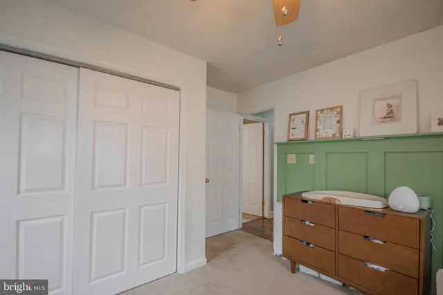 a bedroom with a dresser and window