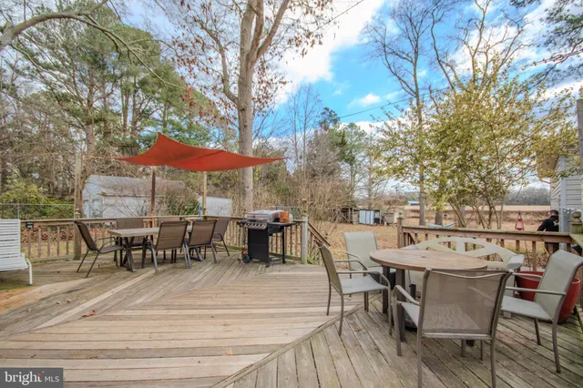 a view of a patio with table and chairs and potted plants