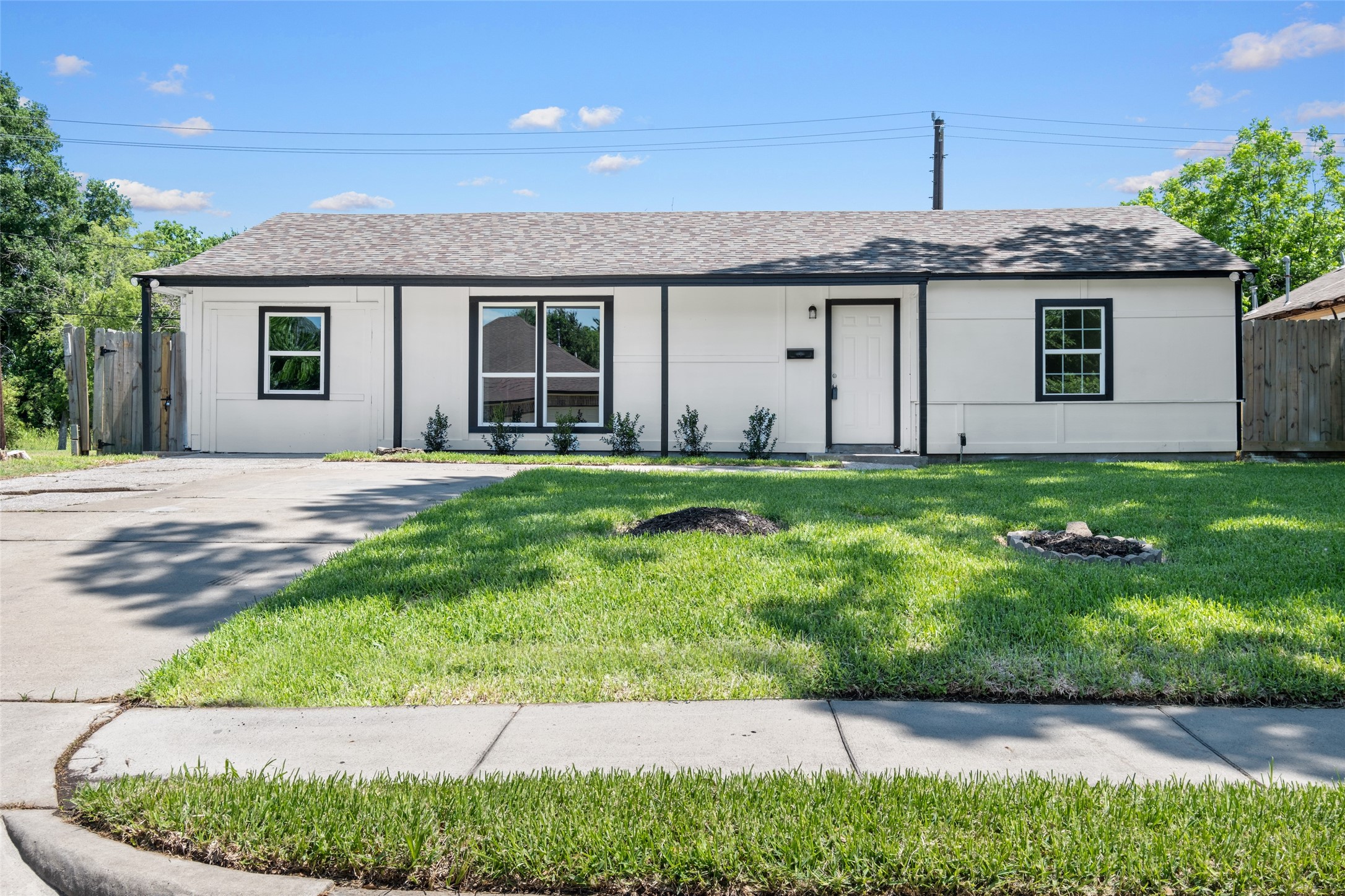 a front view of a house with a garden and yard