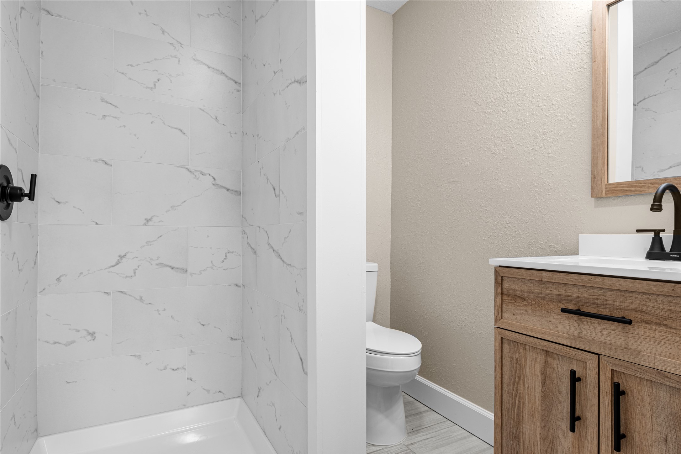 6119 Beekman Road Houston, TX 77021 - Photo 12 of 20 a bathroom with a sink a toilet and a mirror