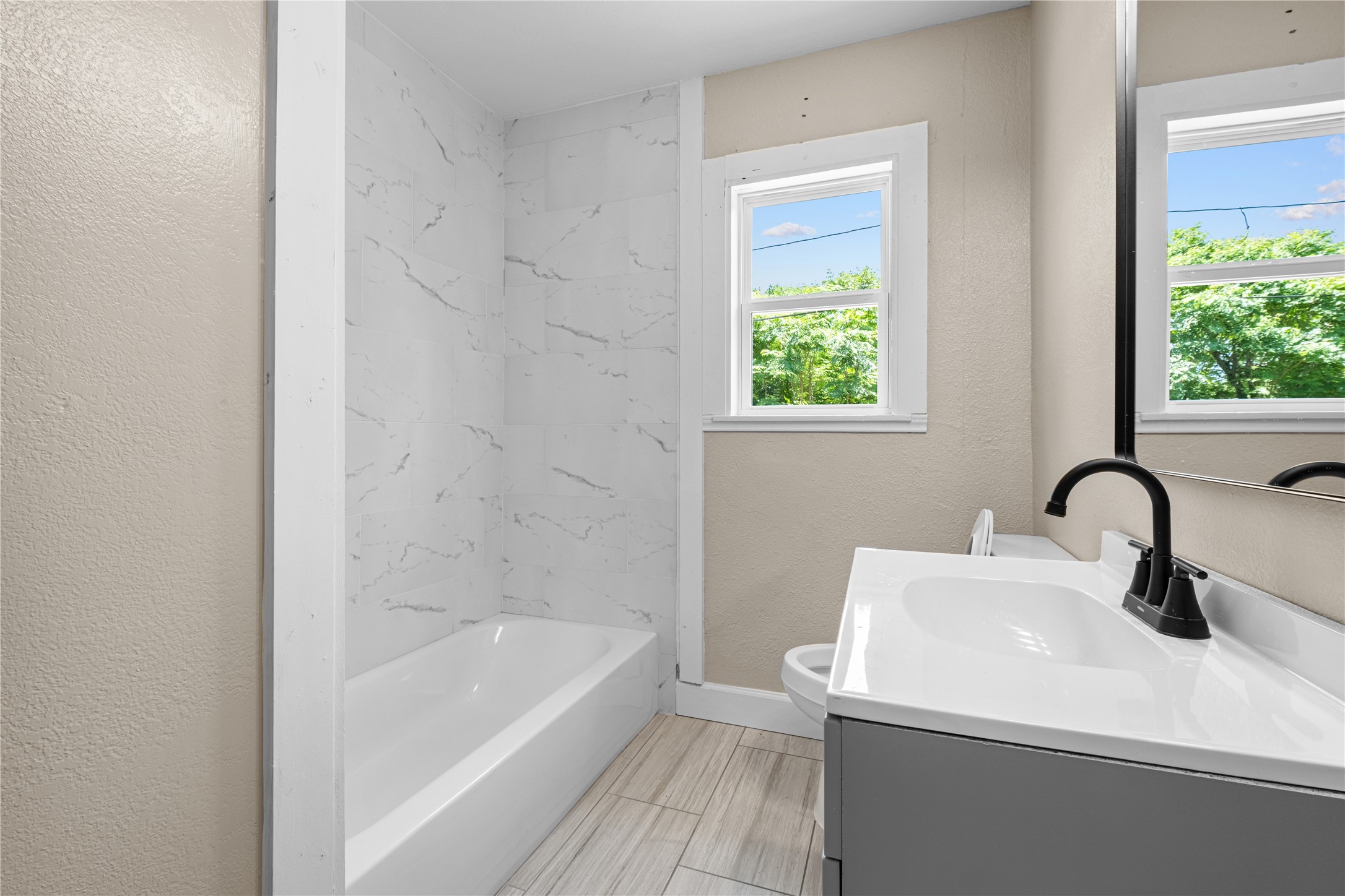 6119 Beekman Road Houston, TX 77021 - Photo 16 of 20 a bathroom with a sink a bathtub and window