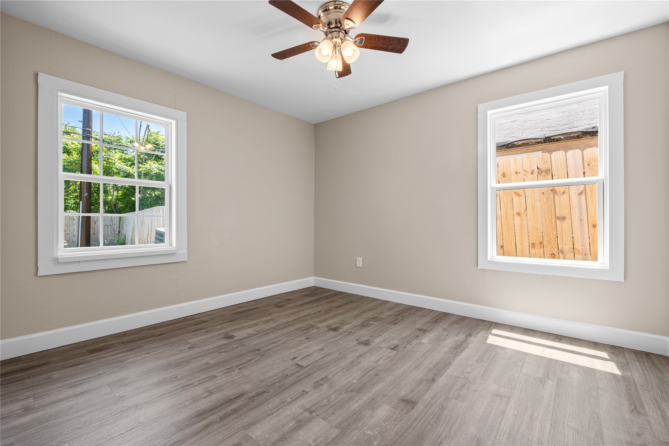 6119 Beekman Road Houston, TX 77021 - Photo 17 of 20 a view of an empty room with a window and wooden floor