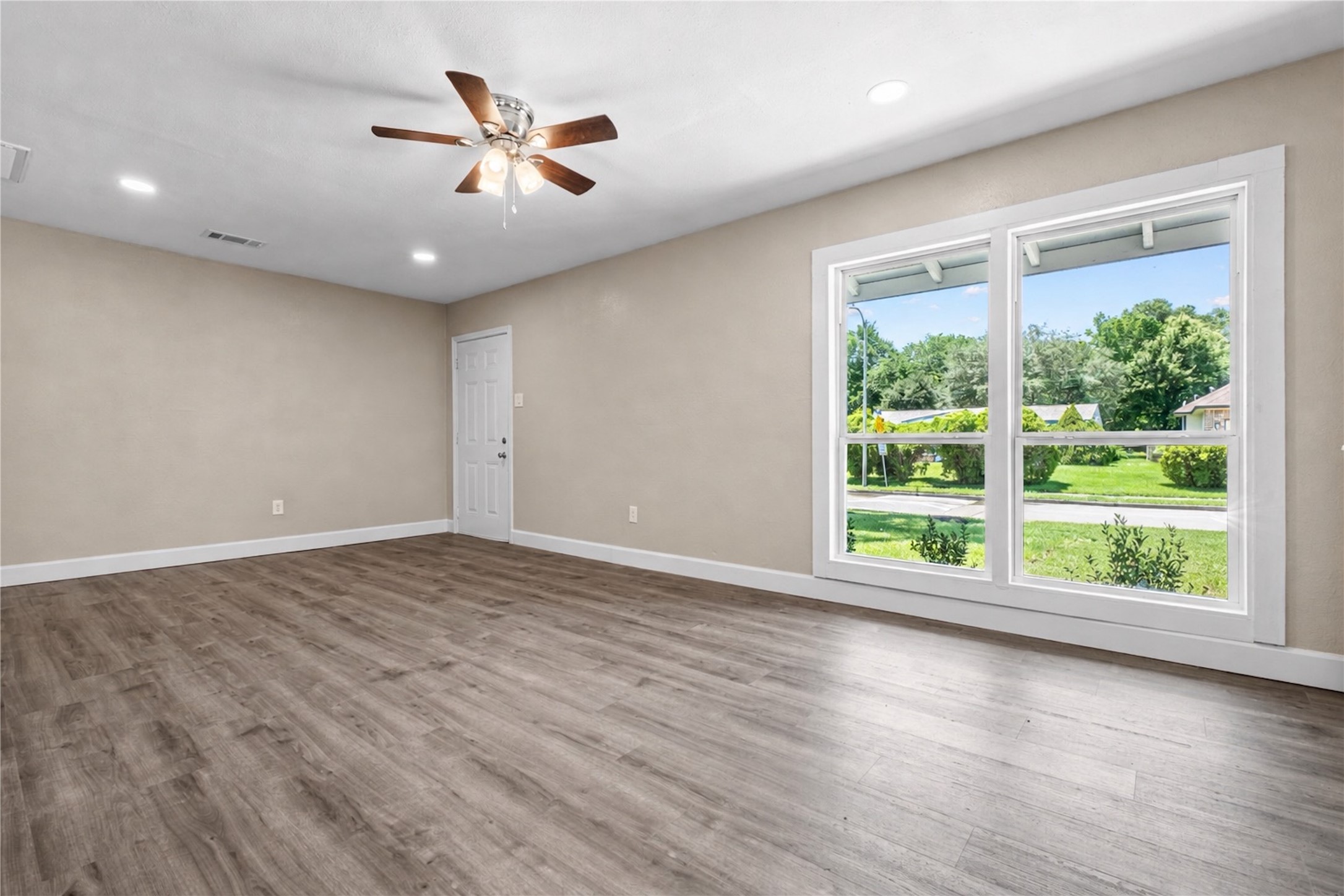 6119 Beekman Road Houston, TX 77021 - Photo 6 of 20 an empty room with wooden floor and windows