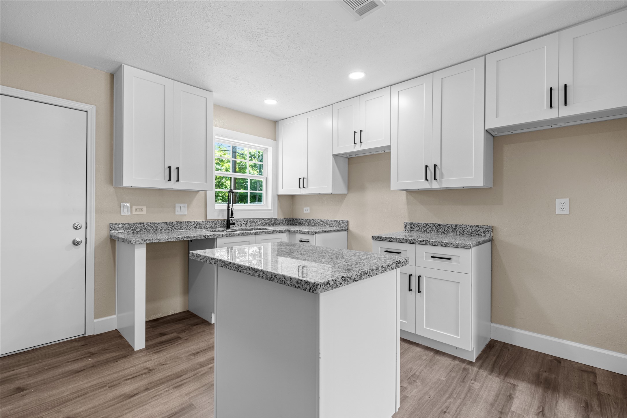 6119 Beekman Road Houston, TX 77021 - Photo 8 of 20 a kitchen with granite countertop white cabinets and white appliances
