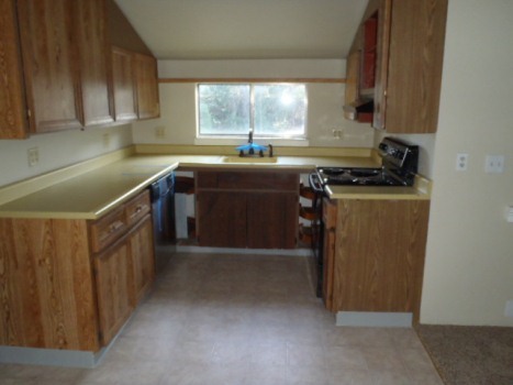 3120 Rancho Road Redding, CA 96002 - Photo 3 of 5 a kitchen with stainless steel appliances granite countertop a sink stove and cabinets