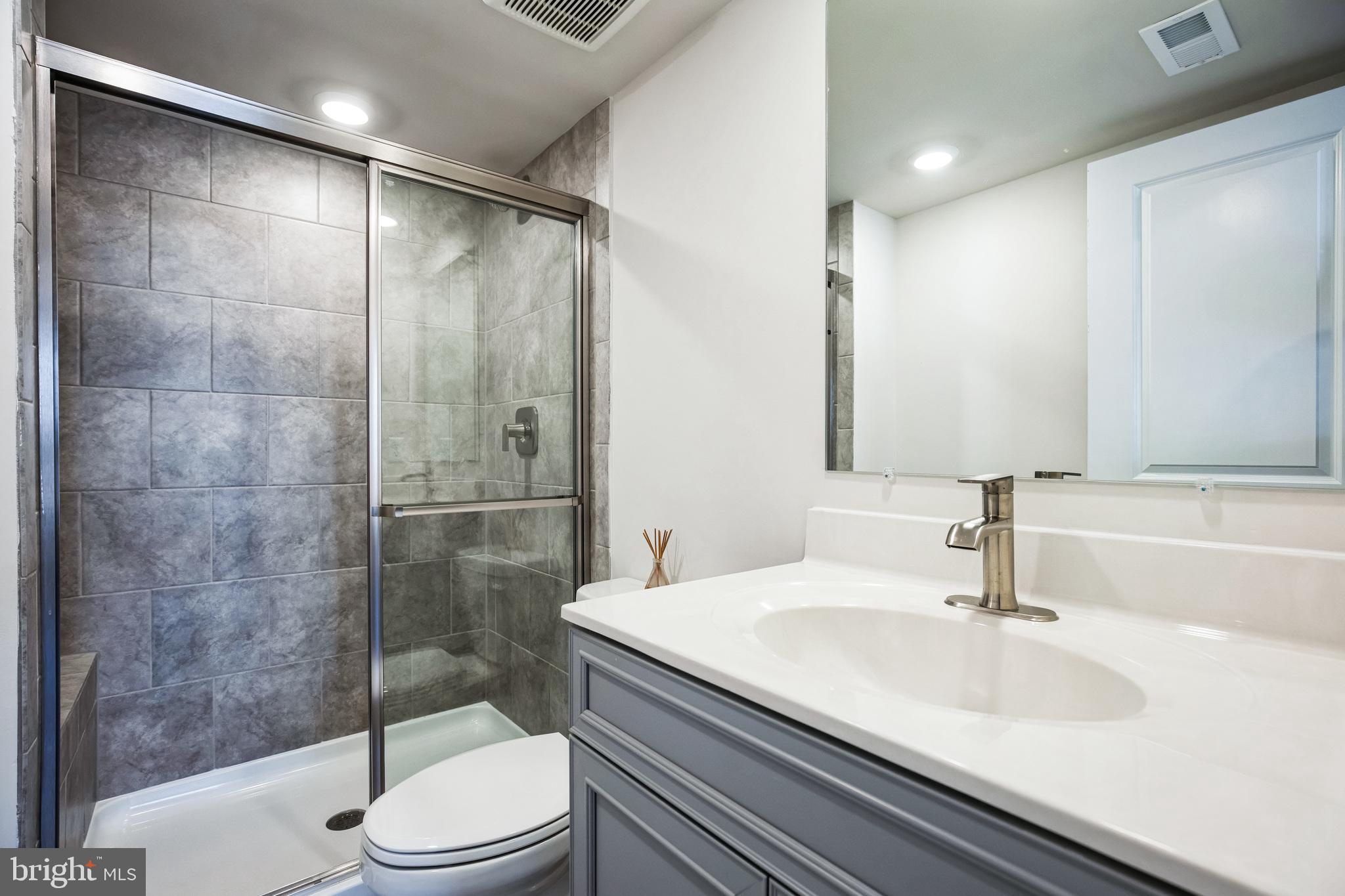 4165 Brodie Place White Plains, MD 20695 - Photo 14 of 28 a bathroom with a sink a toilet and shower