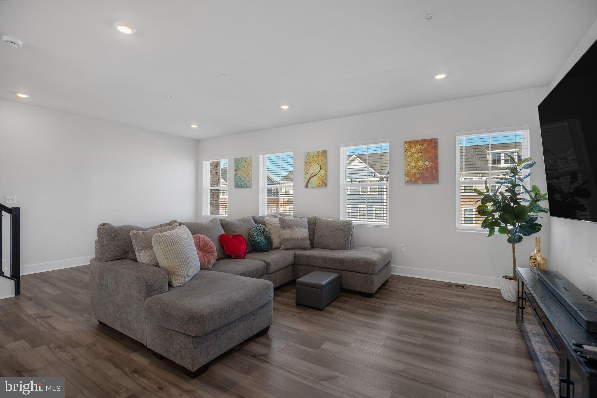 4165 Brodie Place White Plains, MD 20695 - Photo 7 of 28 a living room with furniture a flat screen tv and a potted plant