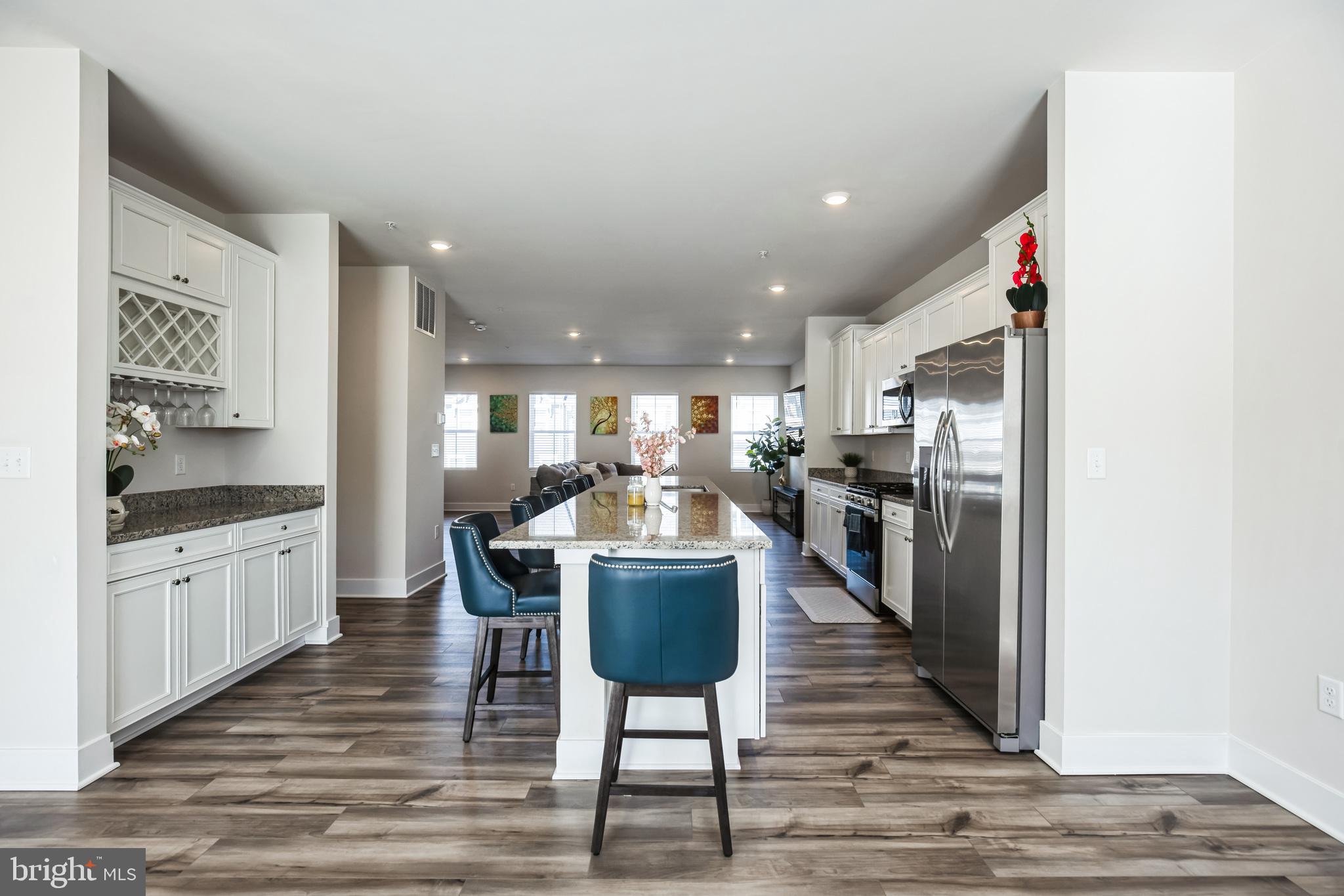 4165 Brodie Place White Plains, MD 20695 - Photo 8 of 28 a kitchen with stainless steel appliances granite countertop a dining table chairs and granite counter tops