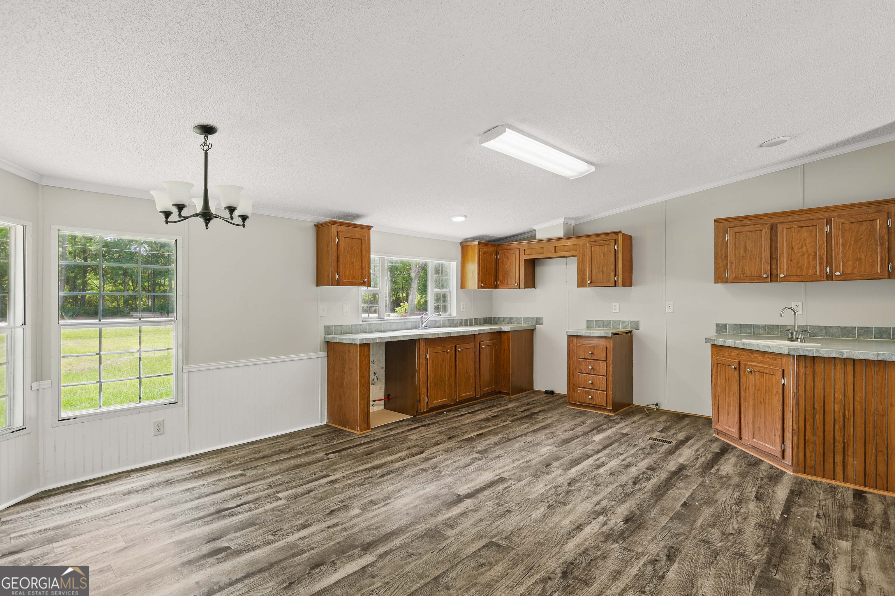 2830 Rincon-Stillwell Road Rincon, GA 31326 - Photo 11 of 52 a view of a kitchen with a sink a fireplace and windows