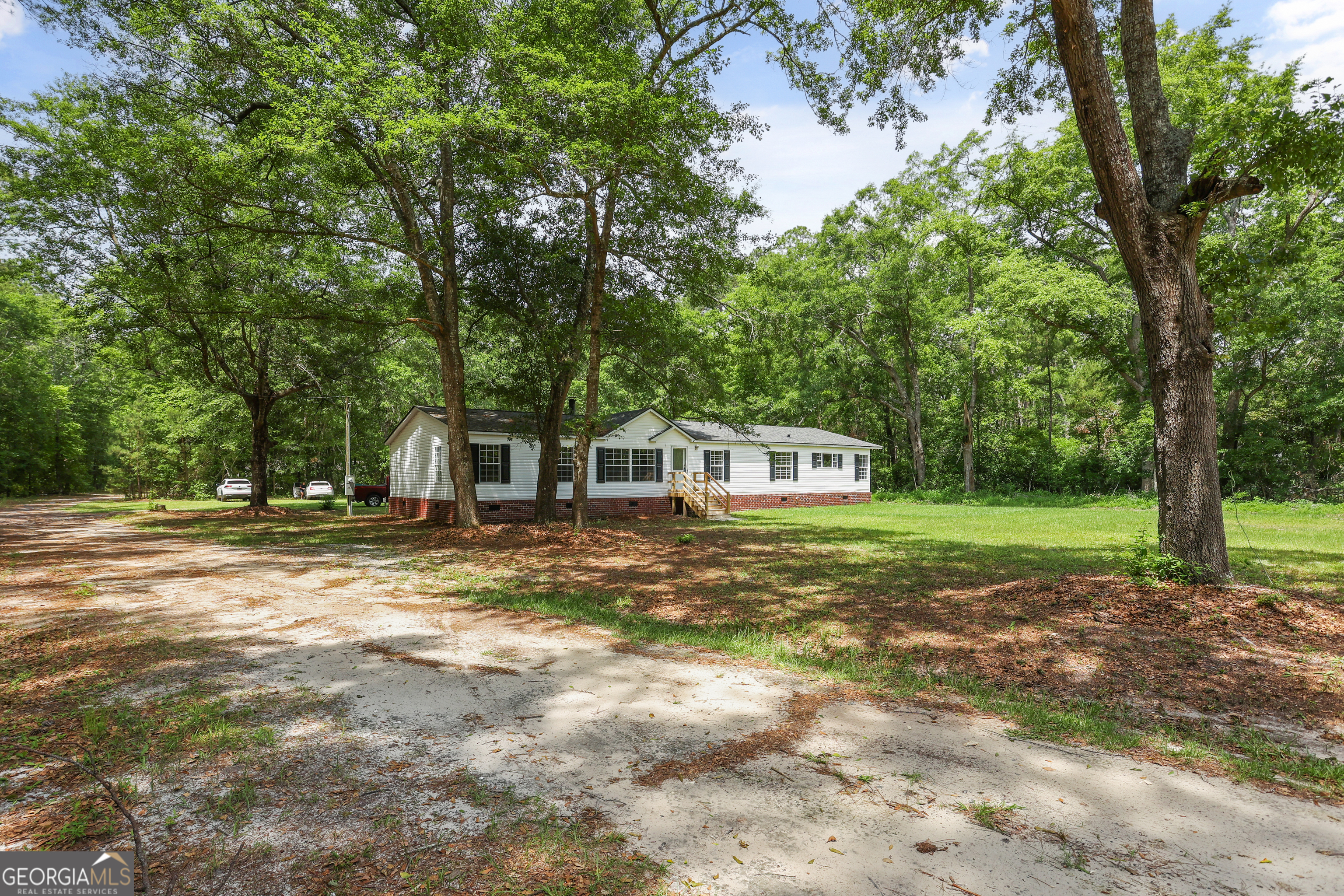 2830 Rincon-Stillwell Road Rincon, GA 31326 - Photo 2 of 52 a front view of a house with a yard