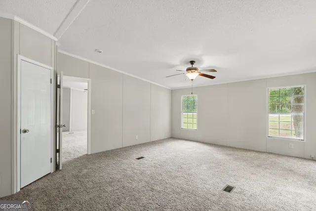 a view of a livingroom with a ceiling fan and window