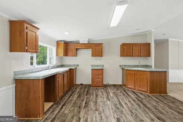 a kitchen with stainless steel appliances granite countertop a sink and wooden cabinets