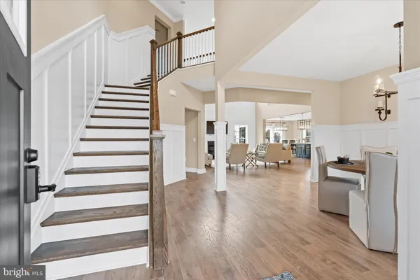 a kitchen with stainless steel appliances a kitchen island hardwood floor sink stove and wooden cabinets