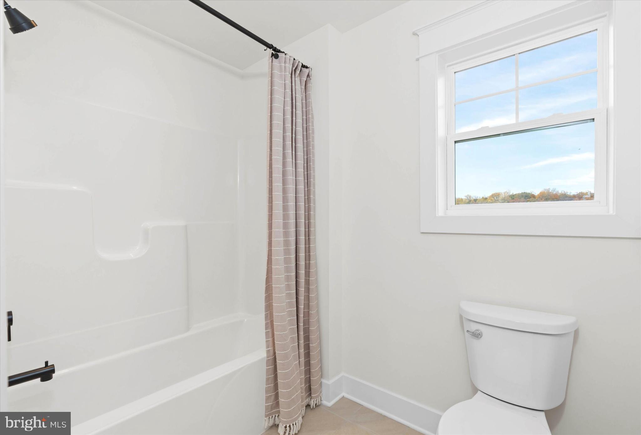 Lot#21 Hummingbird Road Ellendale, DE 19941 - Photo 37 of 66 a bathroom with a toilet and a bathtub