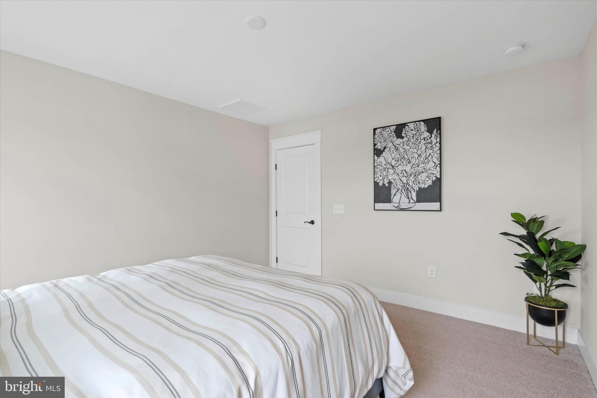 Lot#21 Hummingbird Road Ellendale, DE 19941 - Photo 43 of 66 a bedroom with a bed and a potted plant
