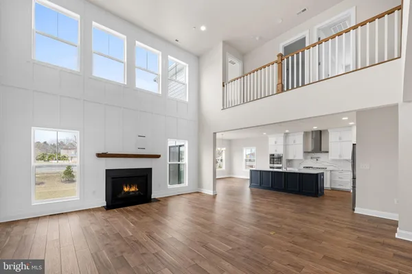 a living room with furniture fireplace and a large window