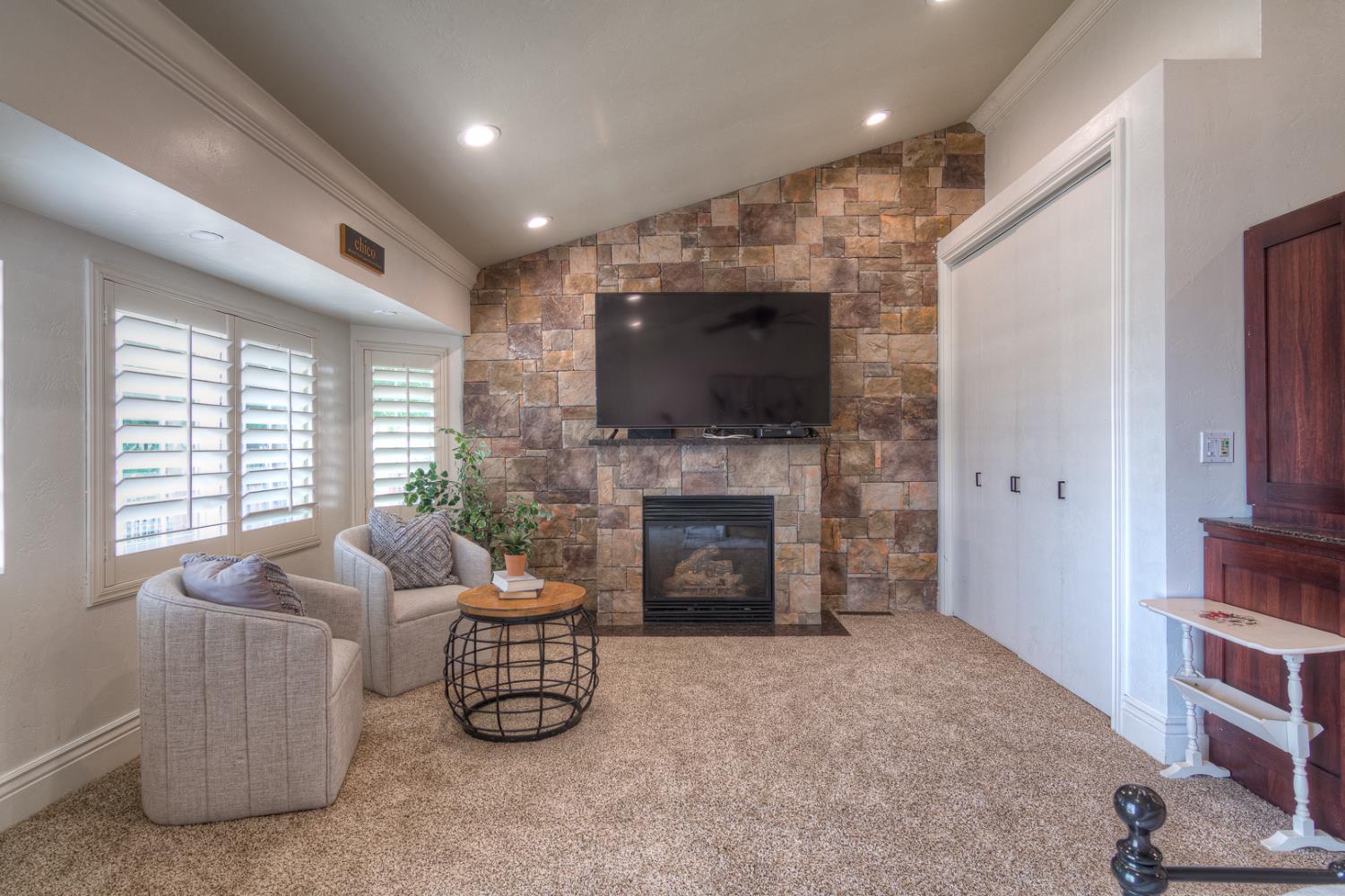 34672 Bernard Road Tracy, CA 95377 - Photo 34 of 80 a living room with furniture a fireplace and a flat screen tv