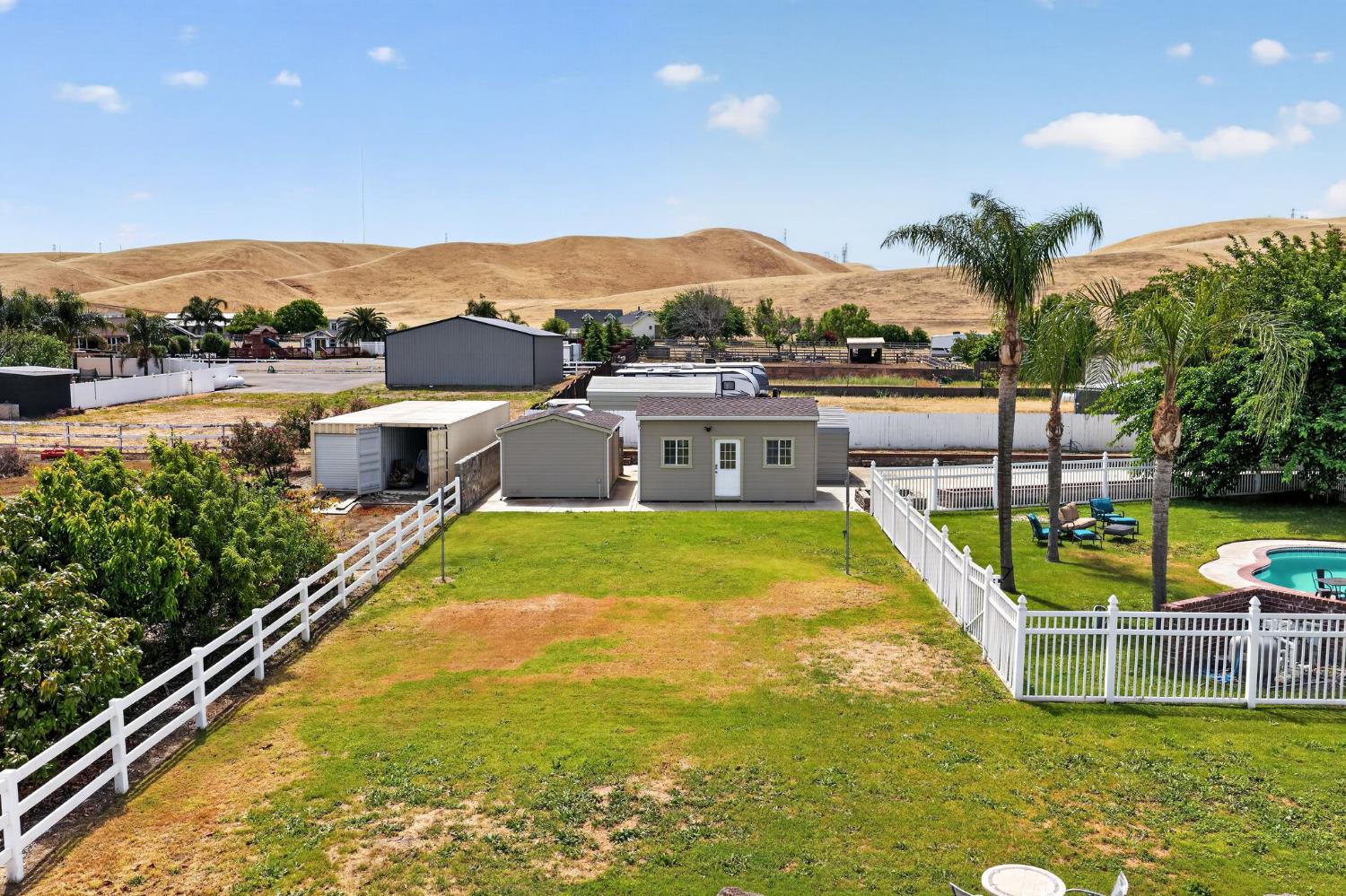 34672 Bernard Road Tracy, CA 95377 - Photo 73 of 80 a view of a swimming pool with a table and chairs