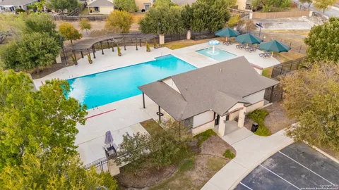 aerial view of a house with swimming pool and porch