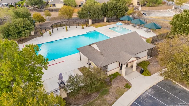 aerial view of a house with swimming pool and porch
