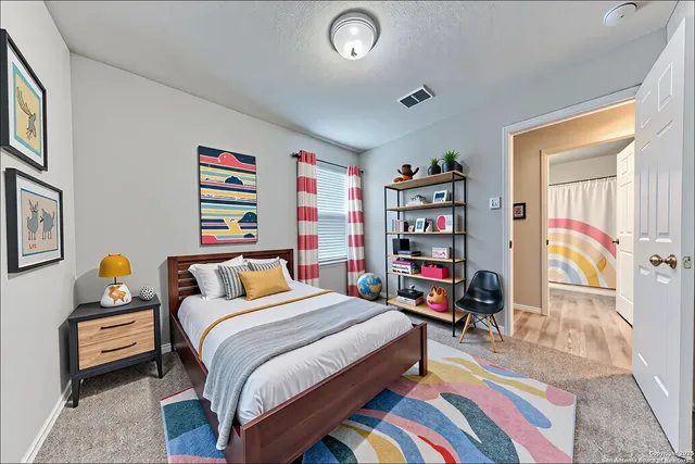a bedroom with a bed a dresser and a book shelf