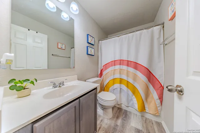 a bathroom with a sink a mirror a bathtub and a shower