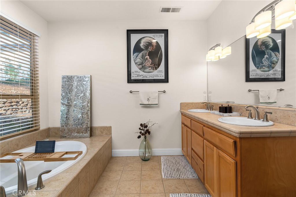 3560 Shadowtree Lane Chico, CA 95928 - Photo 23 of 52 a bathroom with a double vanity sink and a bathtub
