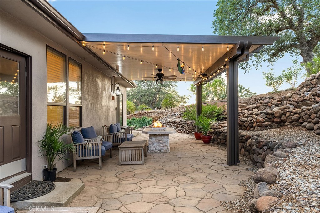 3560 Shadowtree Lane Chico, CA 95928 - Photo 31 of 52 a view of a patio with table and chairs potted plants and floor to ceiling window