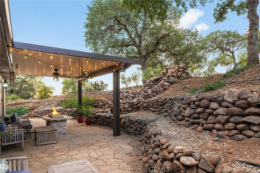3560 Shadowtree Lane Chico, CA 95928 - Photo 32 of 52 a view of a patio with a table and chairs under an umbrella