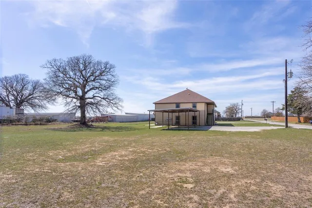 a big house with a big yard and large trees