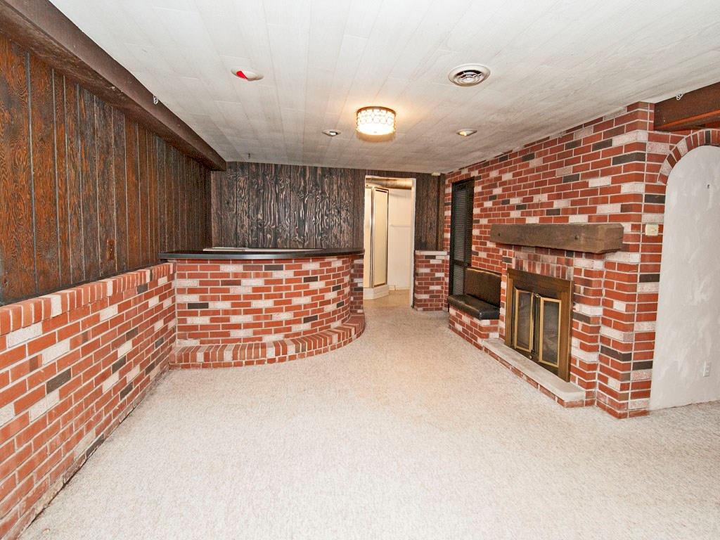 4456 Ellwood Road New Castle, PA 16101 - Photo 18 of 25 Finished lower level has a bar and a gas fireplace.